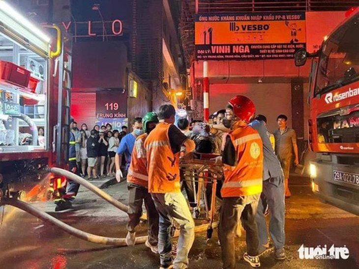 Các nạn nhân xấu số được lực lượng chức năng đưa ra ngoài - Ảnh: MINH THANH  ;